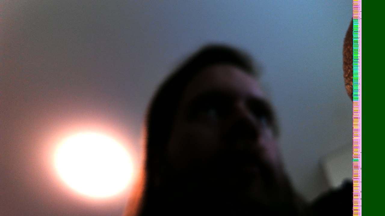 First contact: David beneath a bright ceiling light, with a narrow multicoloured corruption strip and a solid dark-green margin at the right edge.
